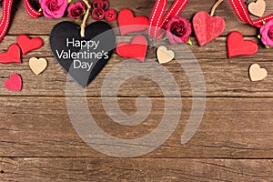 Happy Valentines Day heart shaped chalkboard tag with border against rustic wood