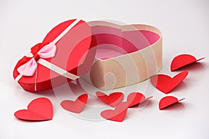 Happy valentines day, opened heart shape gift box with ribbon and small paper hearts, on white background