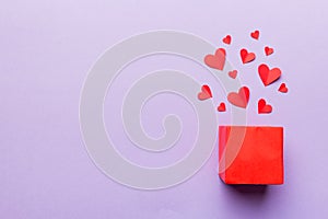 Happy valentines day opened heart shape gift box with small hearts, on colored background, valentines day card - top