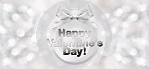 happy valentines day text with shiny silver ribbon bow on blurred background