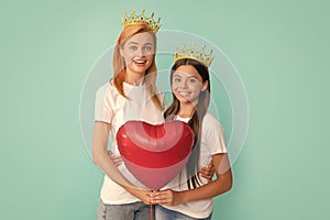 Happy Valentines day to my mom. Selfish mother and daughter hold heart balloon. Valentines day