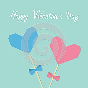 Happy Valentines Day. Two sticks with origami folded paper hearts and bows. Pink and blue pastel colors. Love greeting card templa