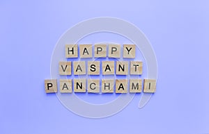 happy Vasant Panchami, a minimalistic banner with an inscription in wooden letters