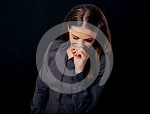 Happy very funny chuckling, laughing fun business beautiful woman covering the mouth the hand looking down on blue shirt on black