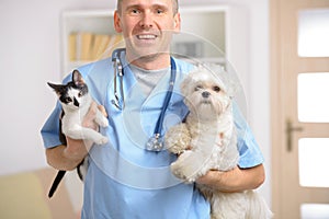 Happy vet with dog and cat photo