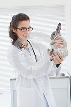 Happy vet petting a cut bunny