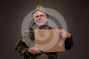 Happy Vietnam Veteran showing a cardboard piece