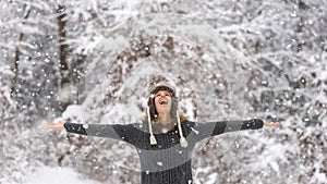 Happy vivacious woman celebrating the snow