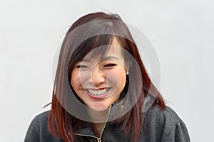 Happy vivacious young Asian woman grinning