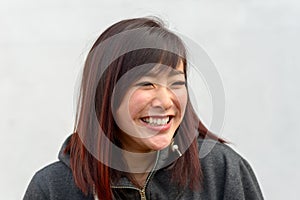 Happy vivacious young Asian woman grinning