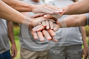 Happy volunteer family putting their hands together