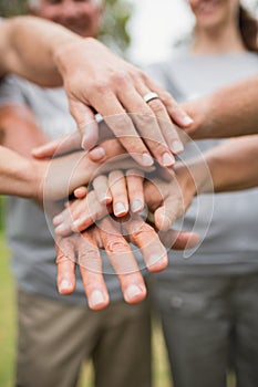 Happy volunteer family putting their hands together