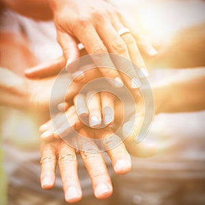 Happy volunteer family putting their hands together