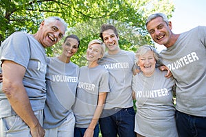 Happy volunteer family smiling at the camera