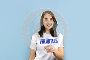 Happy volunteer girl pointing at you