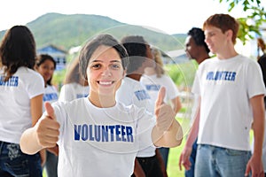 Happy volunteer girl showing thumbs up sign