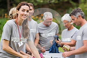 Happy volunteer looking at donation box