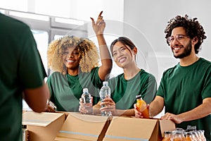 happy volunteers packing food in donation boxes