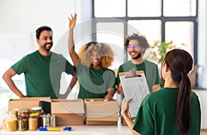 happy volunteers packing food in donation boxes