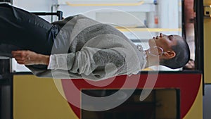 Happy voyager walking platform near high-speed train. Short hair woman vertical