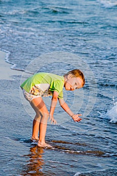 Happy walking child on the sea