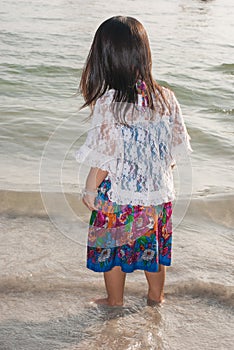 Happy walking child on the sea