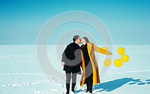 Happy walking couple. In love man and woman walking on the snowy ice. Winter vacation concept.