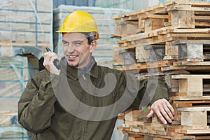 Happy warehouse worker with radio transmitter