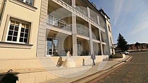 Happy wedding couple meeting at the hotel building on their wedding day