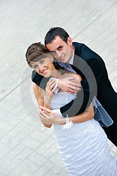 Happy wedding couple standing and embracing