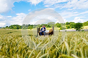 Happy wedding couple in wheat field