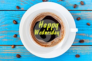 Happy Wednesday on top view coffee cup at blue wooden background with beans