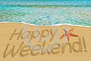 Happy weekend sign on sand and starfish