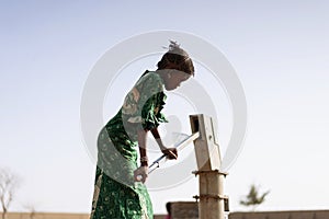Happy West African Women getting healthful Water in a typical village