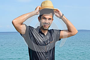 Happy wet man at the seaside. Summer fan