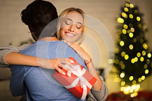Happy wife embracing man, being thankful for present