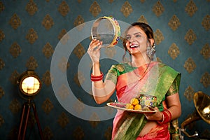 Happy Wife In Saree Holding Pooja Plate In Hand During Karva Chauth Festival