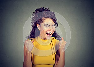 Happy winner. Woman exults pumping fists celebrates success