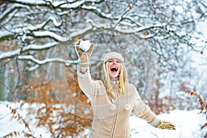 Happy winter game. Woman with snow.