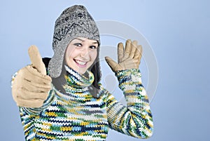 Happy winter girl give thumbs up