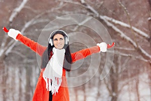 Happy Winter Girl with Headphones Enjoying Snow