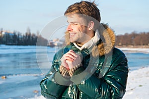 Happy winter holidays. Flu and cold. Winter fashion. Green warm coat. Warm clothes for cold season. Man traveling in