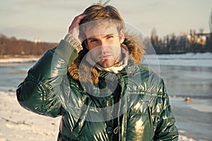 Happy winter holidays. Flu and cold. Winter fashion. Green warm coat. Warm clothes for cold season. Man traveling in