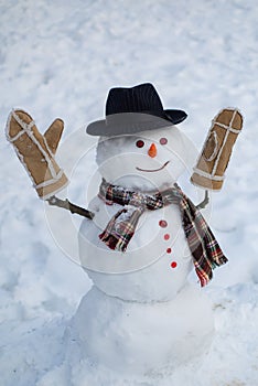 Happy winter time. Christmas snowman on white snow background. Snowman with light star in Christmas day.