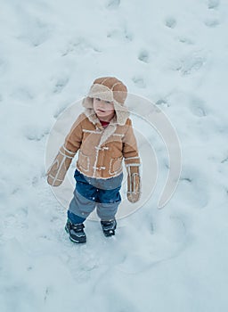 Happy winter time for kid. Winter snow and child game. Winter emotion. Kid playing with snow in park. Joyful little boy