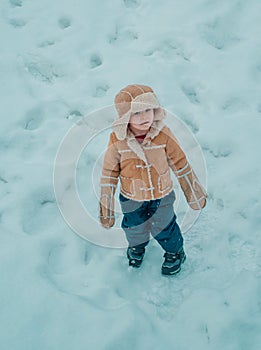 Happy winter time for kid. Winter snow and child game. Winter emotion. Kid playing with snow in park. Joyful little boy
