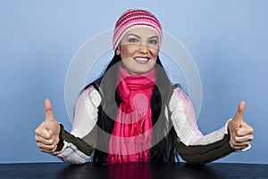 Happy winter woman giving thumbs up