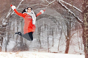 Happy Winter Woman Jumping in the Snow