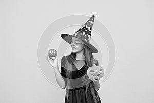 happy witch teenage girl with pumpkin jack o lantern wear costume of wizard on halloween party, halloween jack o lantern