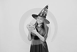 happy witch teenage girl with pumpkin jack o lantern wear costume of wizard on halloween party, halloween pumpkin